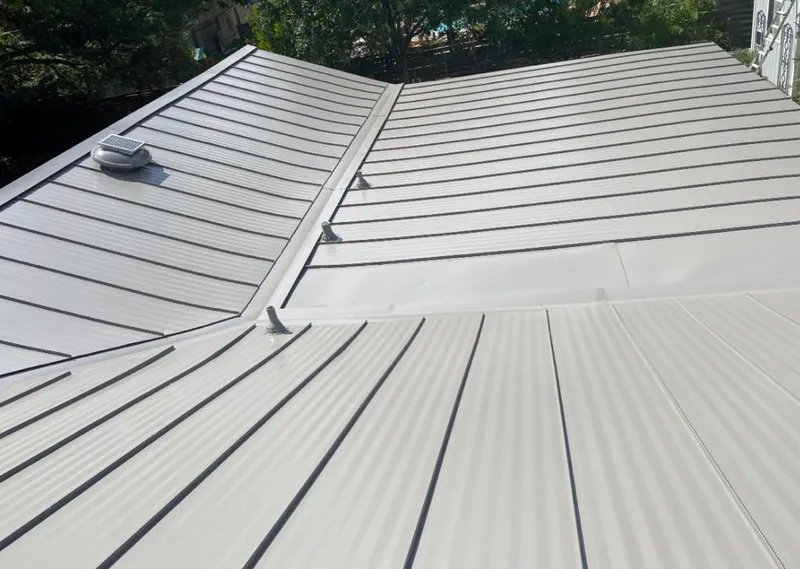 Solar attic fan installed on a metal roof for Roof Ventilation in Lake City