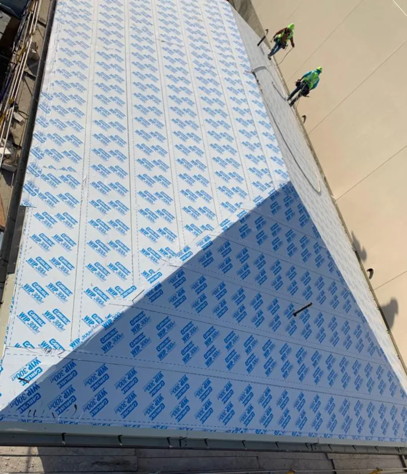 Professional roofers installing underlayment on a metal roof in Lake City